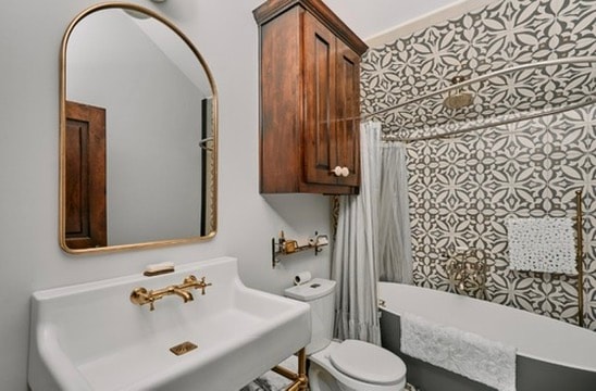 Design consulting — bathroom with patterned tile and gold mirror